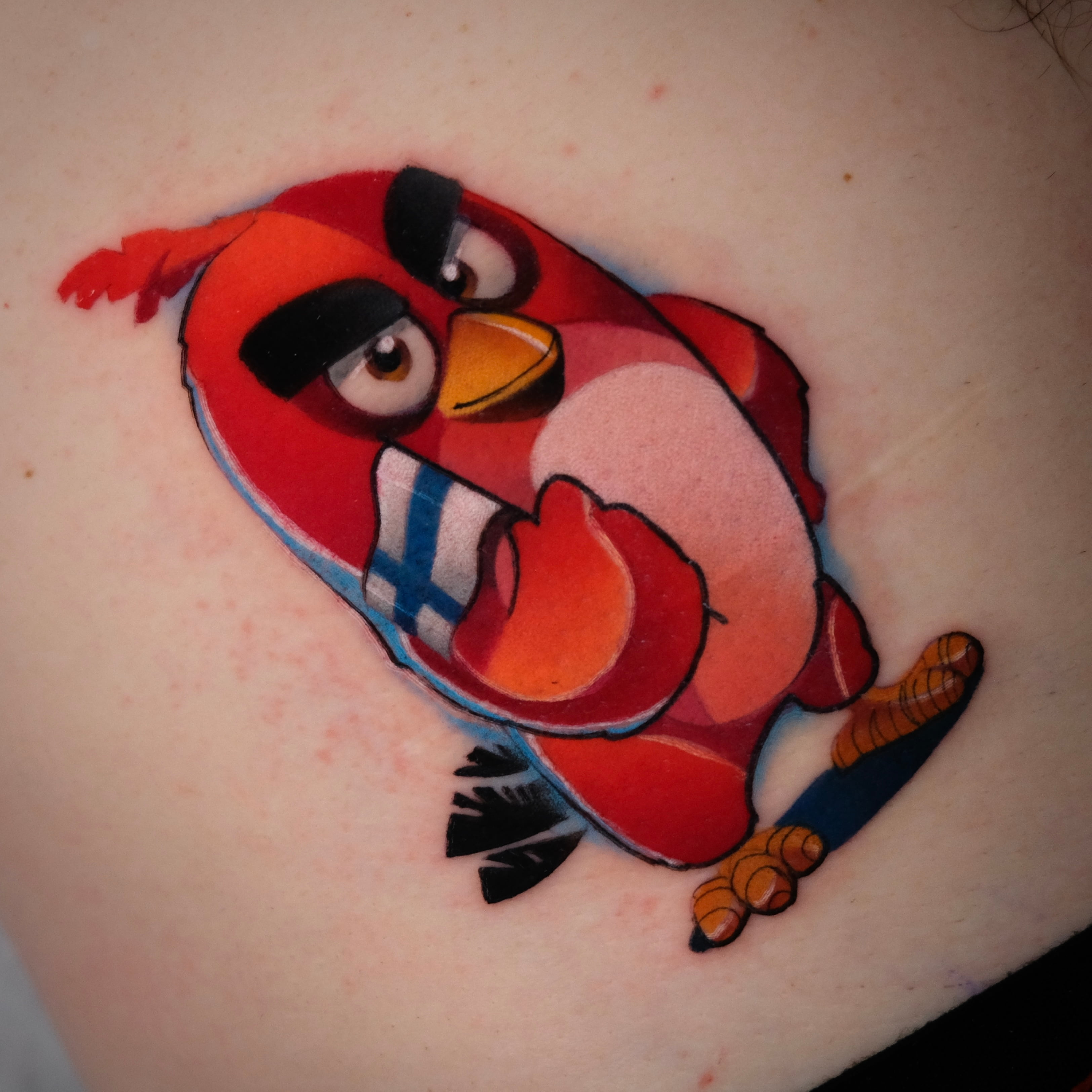 Small colorful cartoon tattoo by Sasha Akulov