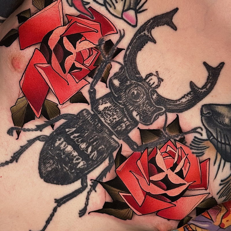 Black and red illustrative tattoo by Sasha Akulov
